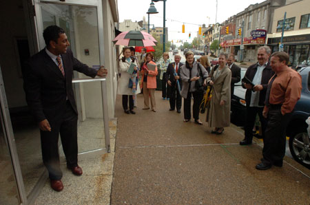 D. Raja (left) welcomes a group taking a tour of the Denis Theatre in Mt. Lebanon. Raja and his wife, Neeta, purchased the building last year and will rent it to the Denis Theatre Foundation, which will operate it as an art house, as well as a venue for lectures and other cultural events.  Photo by Joe Appel/Tribune-Review